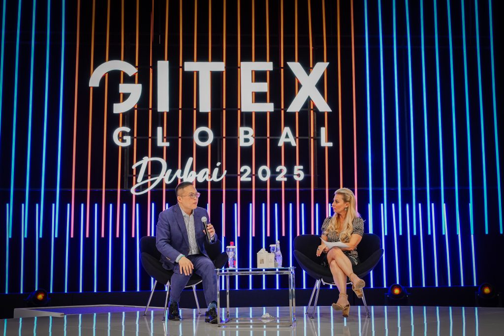Main stage at GITEX Global 2025 in Dubai with speakers discussing technology trends under the event’s illuminated digital backdrop